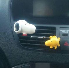 a car air vent with a small yellow dog on it