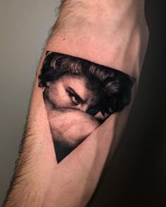 a man's arm with a black and white photo on the side of his leg