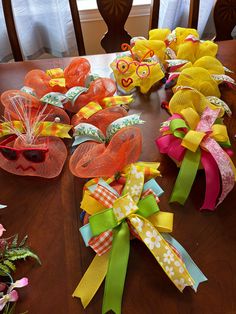 many different colored bows on a wooden table