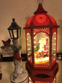 a lighted christmas lantern sitting on top of a table