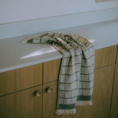 a white and black checkered scarf on top of a counter