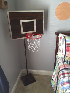 a bed room with a basketball hoop and a neatly made bed