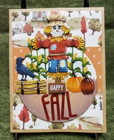 a happy fall card with a scarecrow, pumpkins and a bird on it