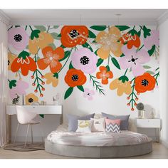 a bedroom with flowers painted on the wall and a round bed in front of it