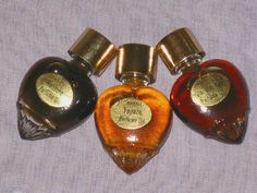 three bottles of perfume sitting next to each other