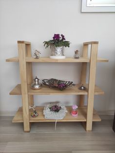 a wooden shelf filled with vases and other items