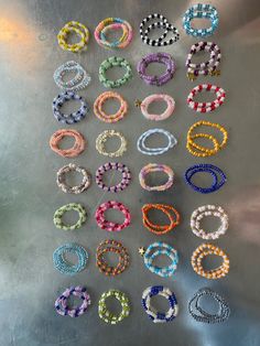 several bracelets are arranged on a metal surface and placed in the shape of rings