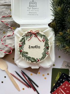 an open christmas gift box sitting on top of a table next to other holiday items