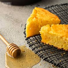 a piece of cake sitting on top of a cooling rack next to a honey comb