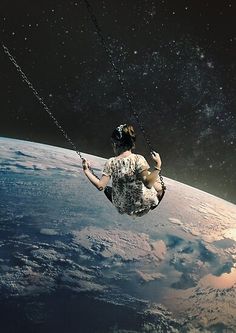 a woman is suspended from a rope above the earth, with space in the background