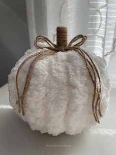 a white pumpkin sitting on top of a table