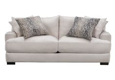 a white couch with two pillows on it