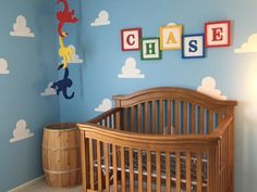 a baby's room decorated in blue and yellow with dr seuss wall decals