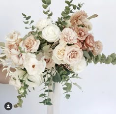 a vase filled with lots of white and pink flowers