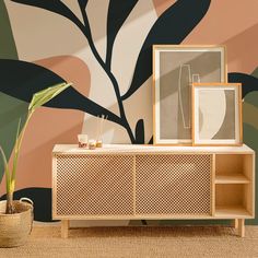 a living room scene with focus on the sideboard and wallpaper that has an abstract design