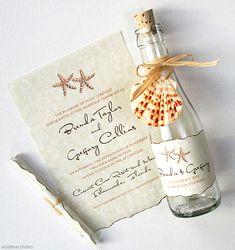 an empty bottle with a seashell in it next to a card and corkscrew