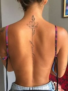 a woman with a flower tattoo on her back