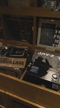 several records are stacked on top of each other in a wooden cabinet with glass doors