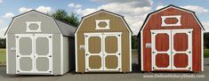 three different colored barns sitting in a parking lot