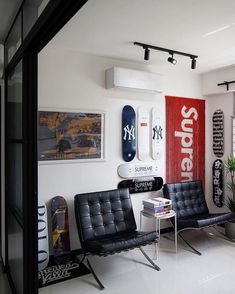 a room with two chairs and surfboards on the wall