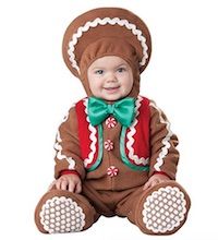 a baby dressed in a gingerbread costume