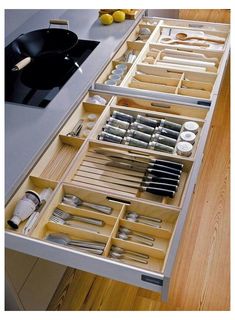 an open drawer in a kitchen filled with utensils