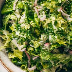 a bowl filled with lettuce and onions