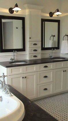 a bathroom with two sinks, mirrors and a bathtub in the middle of it