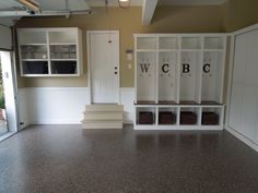 an empty room with white cabinets and shelves