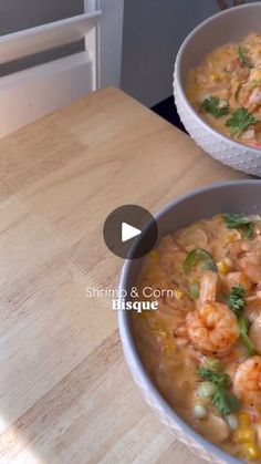 two bowls of shrimp and corn soup on a table