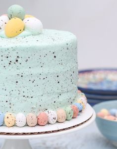 a cake with pastel speckles and eggs on top