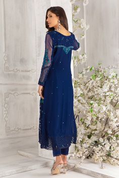 Simple paneled A-line chiffon ensemble, in stunning deep blue hue, featuring botanical embroidery on neckline, hem and sleeves, starburst sequin motifs all over shirt, dazzling sequin and crystals glistening neckline and sleeves. Eye Let embroidery border and pearls dangling’s complete the look. This stunning shirt is paired with straight pant and color-block dupatta featuring floral embroidery borders and trimmed with lace. A wardrobe must have. Shirt & dupatta Fabric: Pure Chiffon Shirt Length Festive Party Sets With Embroidered Neckline, Party Sets With Embroidered Neckline For Eid, Blue Hand Embellished Georgette Dress, Elegant Blue Sets With Sequins, Elegant Blue Sequined Sets, Blue Hand Embellished Party Dress, Elegant Party Sets With Embroidered Neckline, Long Sleeve Georgette Dresses With Sequins, Long Sleeve Georgette Sequin Dress