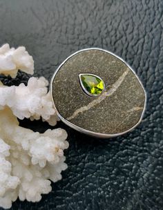 Please contact me if you want me to fabricate a similar ring. A large beach rock from the shore of northern California is inlaid with a beautiful peridot. Custom made for Alex. Pebble Jewelry, Beach Rocks, Peridot Ring, Raw Stone, Custom Bracelets, Multi Stone, Multi Stone Ring, Sterling Ring, Stone Rings