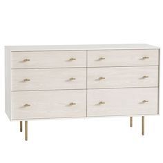 a white dresser with gold handles on it's legs and drawers, against a white background