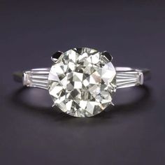 an old mine cut diamond engagement ring with baguets on the shoulders and sides