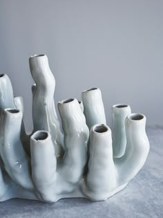 a group of white vases sitting on top of a table