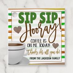 there is a coffee cup and saucer on the table with a sign that says sip hooray