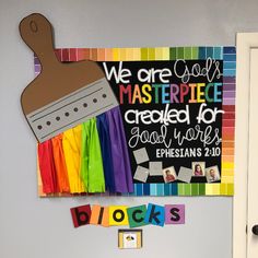 a bulletin board that has been made to look like a painting brush and blocks on it