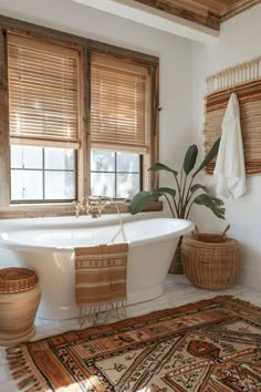 a white bath tub sitting next to a window with bamboo shades on the windowsill