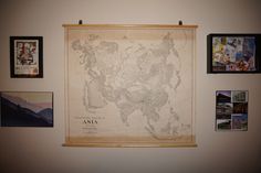 a map hanging on the wall with pictures around it