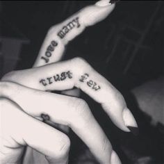 two people with tattoos on their fingers saying i love you very and trust me too