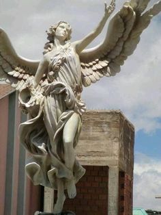 an angel statue is shown in front of a building