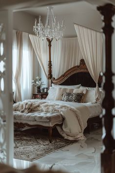 a bedroom with a canopy bed, chandelier and white drapes on the windows