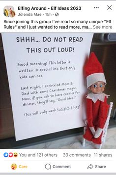 an elf is holding a sign that says shh do not read this out loud