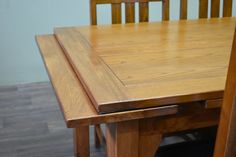 a wooden table with two chairs next to it