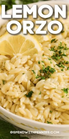 lemon orzo pasta in a white bowl with parsley and lemon wedges on the side