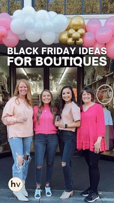 four girls standing in front of a black friday sign with balloons and pink shirts on