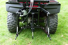 the rear end of a four - wheeler on grass