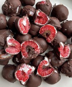 chocolate covered blood oranges are on a plate