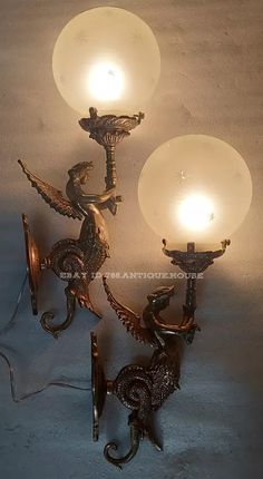 two sconces with lights attached to them